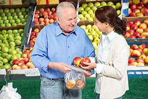 Woman and man shopping for fruit